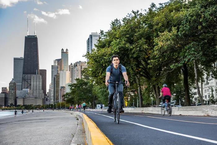 bicyclist on a path in a big city